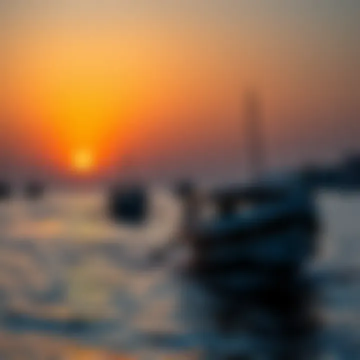 Traditional dhow boats sailing against a vibrant sunset